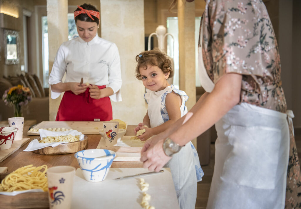 Bambini che impastano in cucina con lo chef